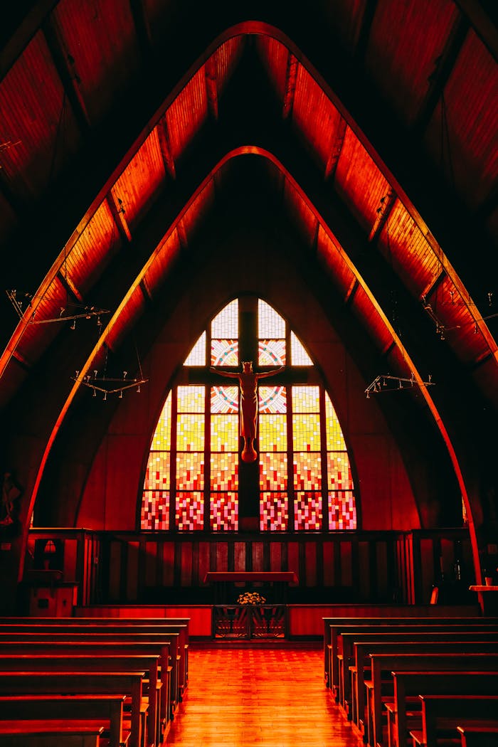 services-02 A stunning church interior with vibrant stained glass windows and wooden pews.